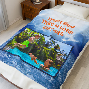 Plush velveteen blanket with “Leap of Faith” design, child jumping into pool, inspirational message